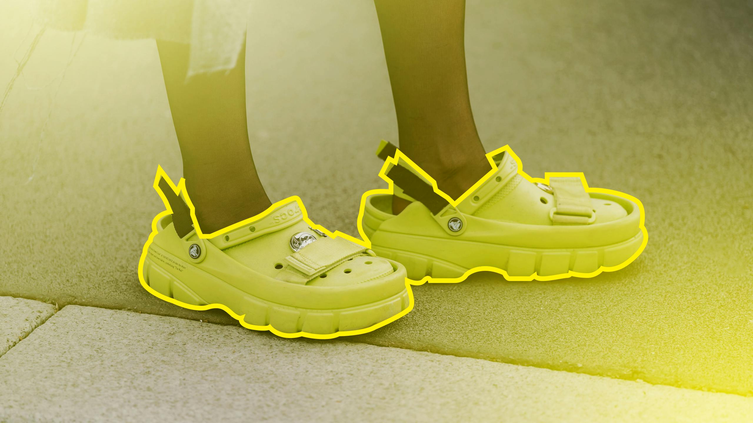 A trendy person wearing Crocs, and the crocs are outlined in yellow