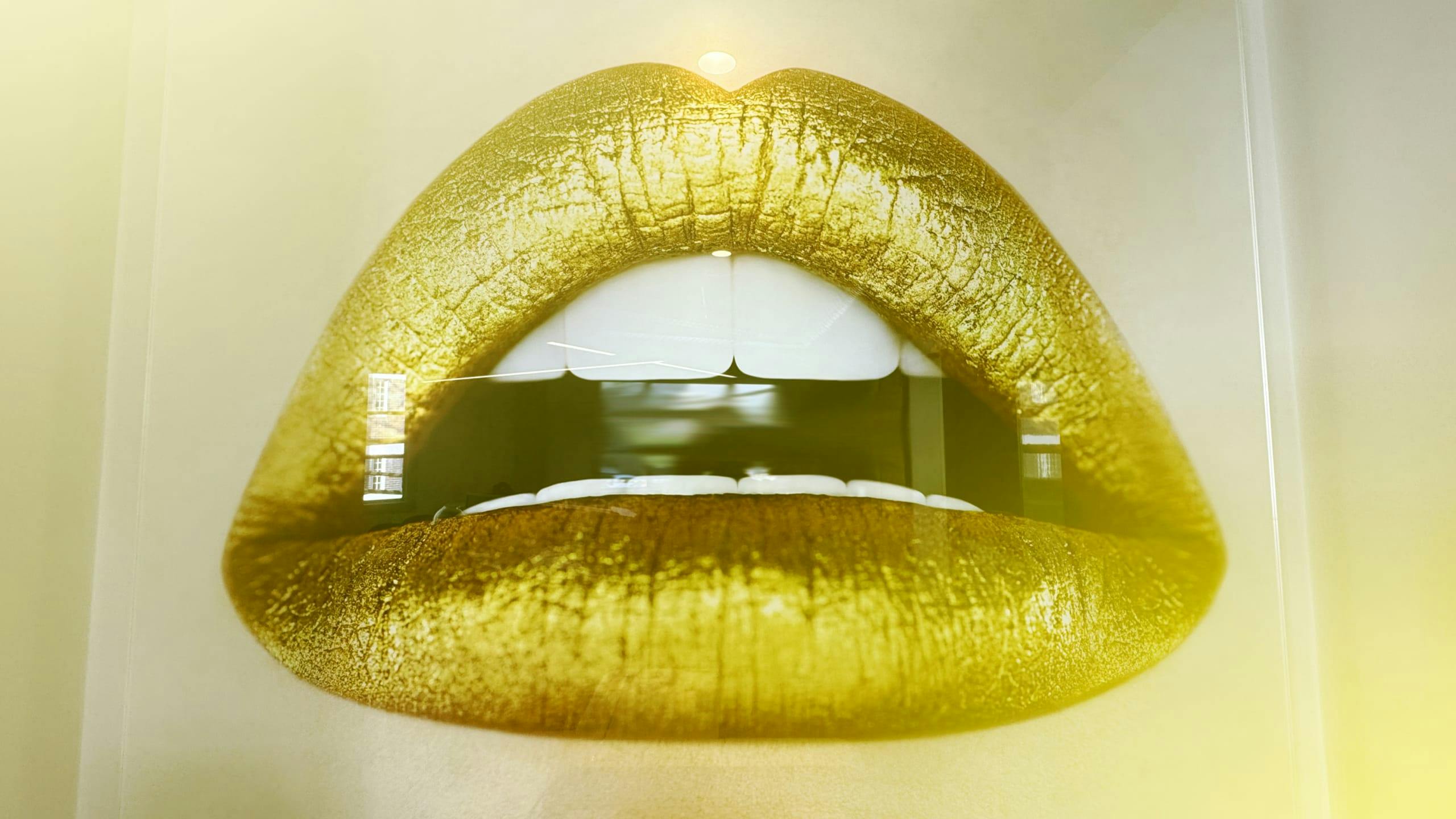 An artwork depicting golden lips in the AFFINITY offices